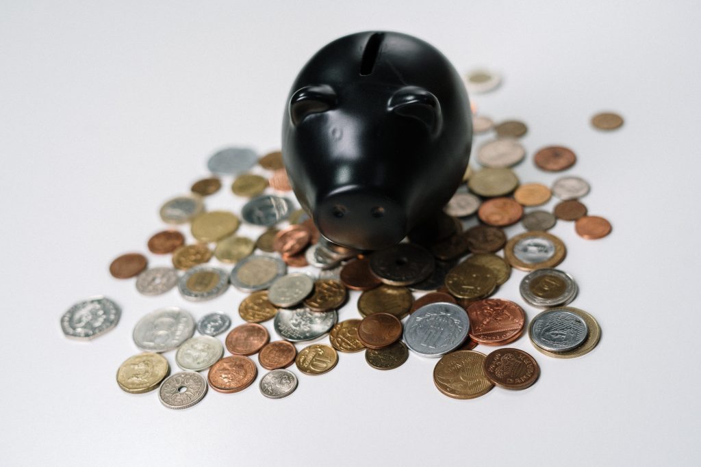 "Piggy bank with a stack of coins falling into it symbolizing savings and financial planning." RRSP vs. TFSA